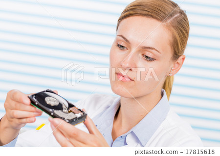 Woman in laboratory with hdd in hand Woman in laboratory with hdd in hand 17815618
