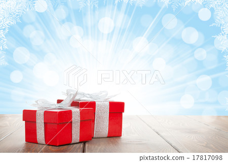Christmas gift boxes on wooden table with bokeh Christmas gift boxes on wooden table with bokeh 17817098
