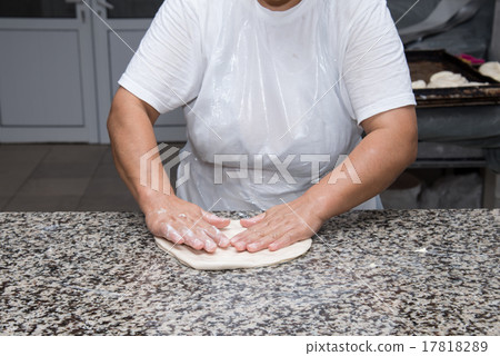 female hands kneading dough and making banitsa 17818289