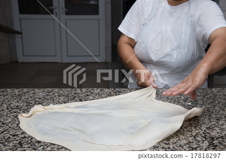 female hands kneading dough and making banitsa 17818297