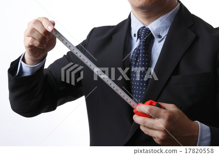 A businessman measuring with a measure 17820558