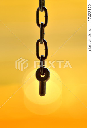 close up key in the last chain on warm yellow back 17822170