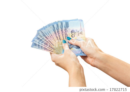 Thai Banknote money in female hand, isolated on white background Thai Banknote money in female hand, isolated on white background 17822715