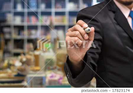 Businessman writing the board on Abstract blurred photo of book Businessman writing the board on Abstract blurred photo of book 17823174