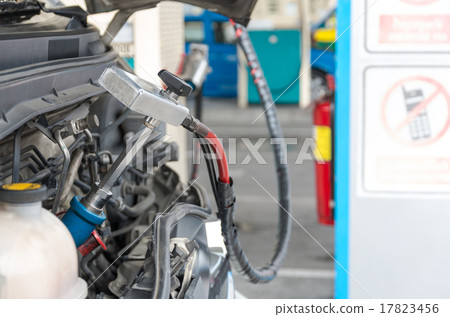 Gas nozzle to add gas in car at gas station 17823456