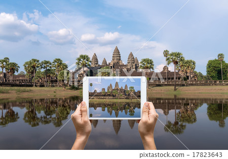 Female hands holding tablet taking pictures Angkor Wat at Siem R Female hands holding tablet taking pictures Angkor Wat at Siem R 17823643