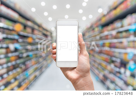 Female hand holding mobile smart phone on Supermarket blur backg Female hand holding mobile smart phone on Supermarket blur backg 17823648