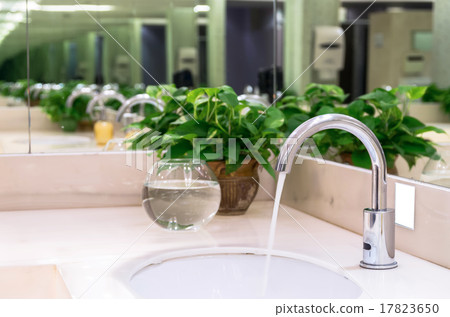 Chrome faucet with washbasin in modern bathroom Chrome faucet with washbasin in modern bathroom 17823650