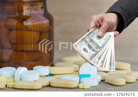 Businessman Hand with usd dollar money for Many Pills and vitami 17824273