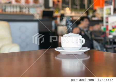 Coffee cup on coffee shop blur background Coffee cup on coffee shop blur background 17825352