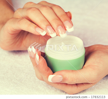 jar with cream in female hands 17832113