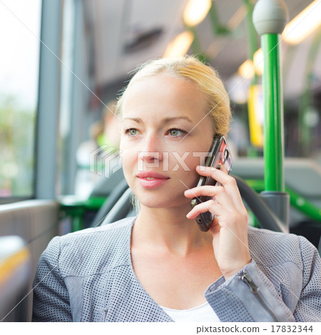 Blonde business woman traveling by bus. 17832344