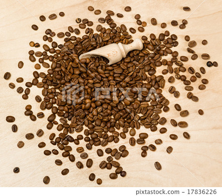 coffee seeds with wooden shovel on wood background coffee seeds with wooden shovel on wood background 17836226