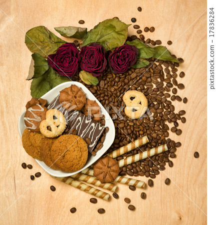 dry red roses and cookies on coffee seeds 17836284