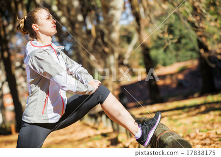 Young fit girl stretching out on bench before Young fit girl stretching out on bench before 17838175