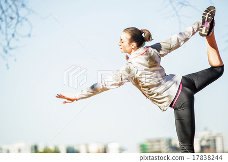 Young woman stretching out on bench before jogging Young woman stretching out on bench before jogging 17838244
