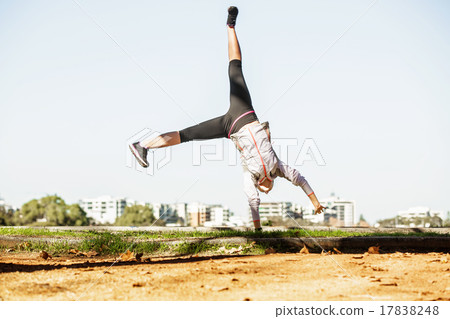 Young fit woman doing simple acrobatics exercise Young fit woman doing simple acrobatics exercise 17838248