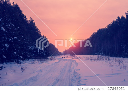 Sunrise over snowy road in the forest Sunrise over snowy road in the forest 17842051