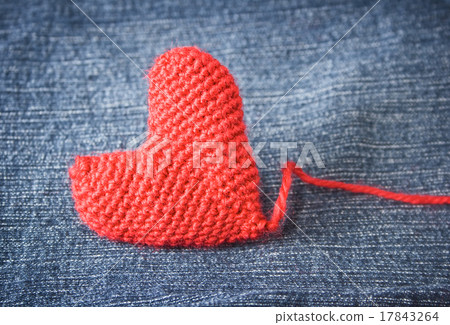 Knitted heart on blue jeans texture background 17843264