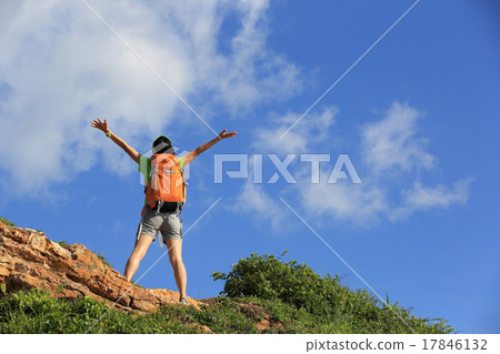 cheering young woman backpacker enjoy the view  17846132