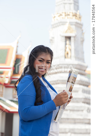 Woman smiling and holding a map. 17848564
