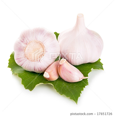 Garlic on green leaf close-up isolated 17851726