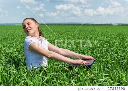 woman with notebook in the green field 17852890
