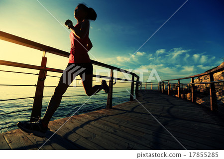 woman running on wooden boardwalk sunrise seaside woman running on wooden boardwalk sunrise seaside 17855285