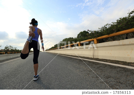 young woman runner ready for run on city road young woman runner ready for run on city road 17856313