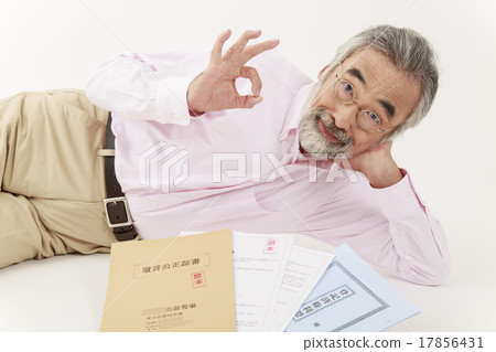 Male senior lying next to a will testimony and real estate registry 17856431