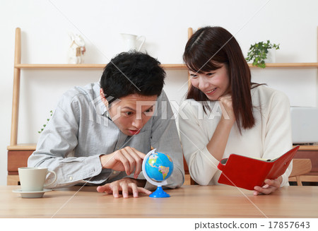 A young couple planning a honeymoon 17857643