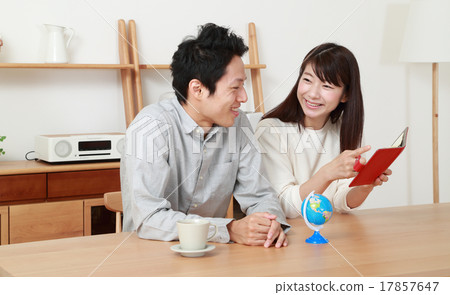 A young couple planning a honeymoon 17857647