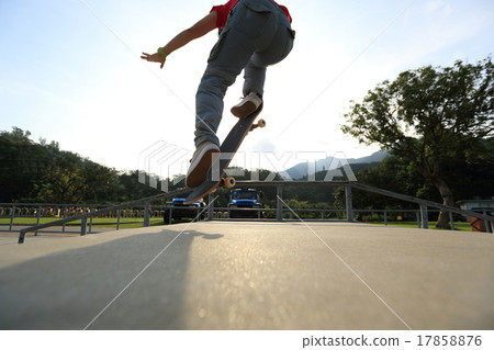 skateboarder legs doing a ollie at skatepark skateboarder legs doing a ollie at skatepark 17858876