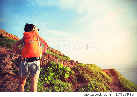 woman hiker climbing on seaside mountian trail woman hiker climbing on seaside mountian trail 17858919