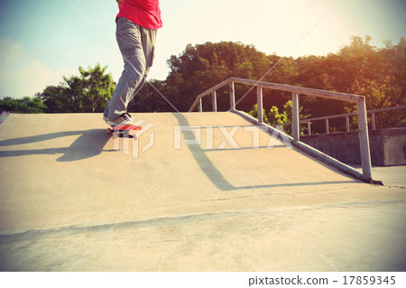 skateboarder legs riding skateboard at skatepark skateboarder legs riding skateboard at skatepark 17859345