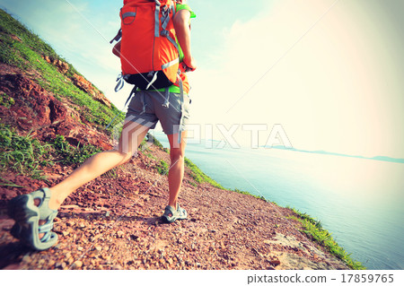 young woman backpacker walking on seaside young woman backpacker walking on seaside 17859765