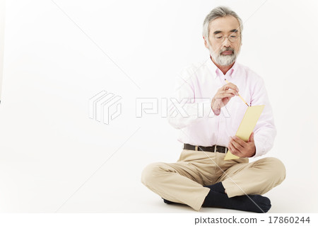 Senior men sitting and writing haiku with brush on strips Senior men sitting and writing haiku with brush on strips 17860244