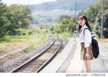 A pretty school girl who waits for a train at the station home A pretty school girl who waits for a train at the station home 17862283