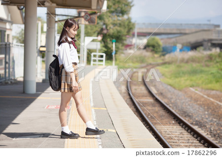 A pretty school girl who waits for a train at the station home A pretty school girl who waits for a train at the station home 17862296