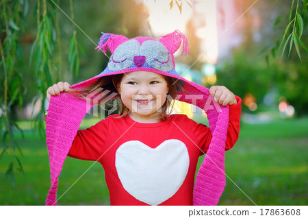 Beautiful laughing little toddler girl in a red coat and colorfu Beautiful laughing little toddler girl in a red coat and colorfu 17863608