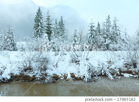 Small winter stream with snowy trees. 17865162