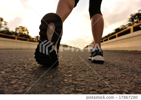young fitness asian woman runner legs running on road 17867280