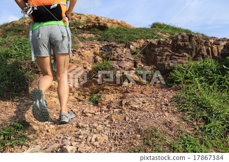 young woman backpacker climbing to mountain peak 17867384