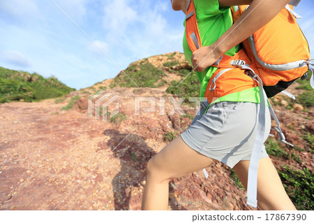 young woman backpacker climbing on mountain trail 17867390