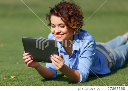 Pleasant girl resting on the grass Pleasant girl resting on the grass 17867568