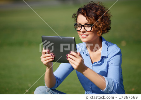 Pleasant girl resting on the grass Pleasant girl resting on the grass 17867569