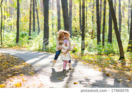Little girl and her mother playing in the park 17868076