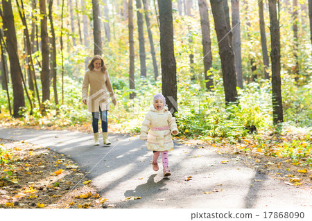Mother and daughter walking in the autumn park 17868090