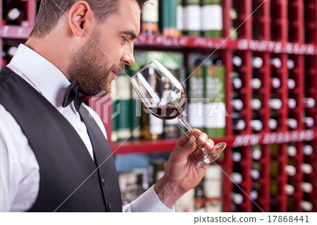 Attractive male sommelier is tasting alcohol drink 17868441