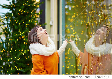 Young girl looking at Parisian shop-windows Young girl looking at Parisian shop-windows 17871385